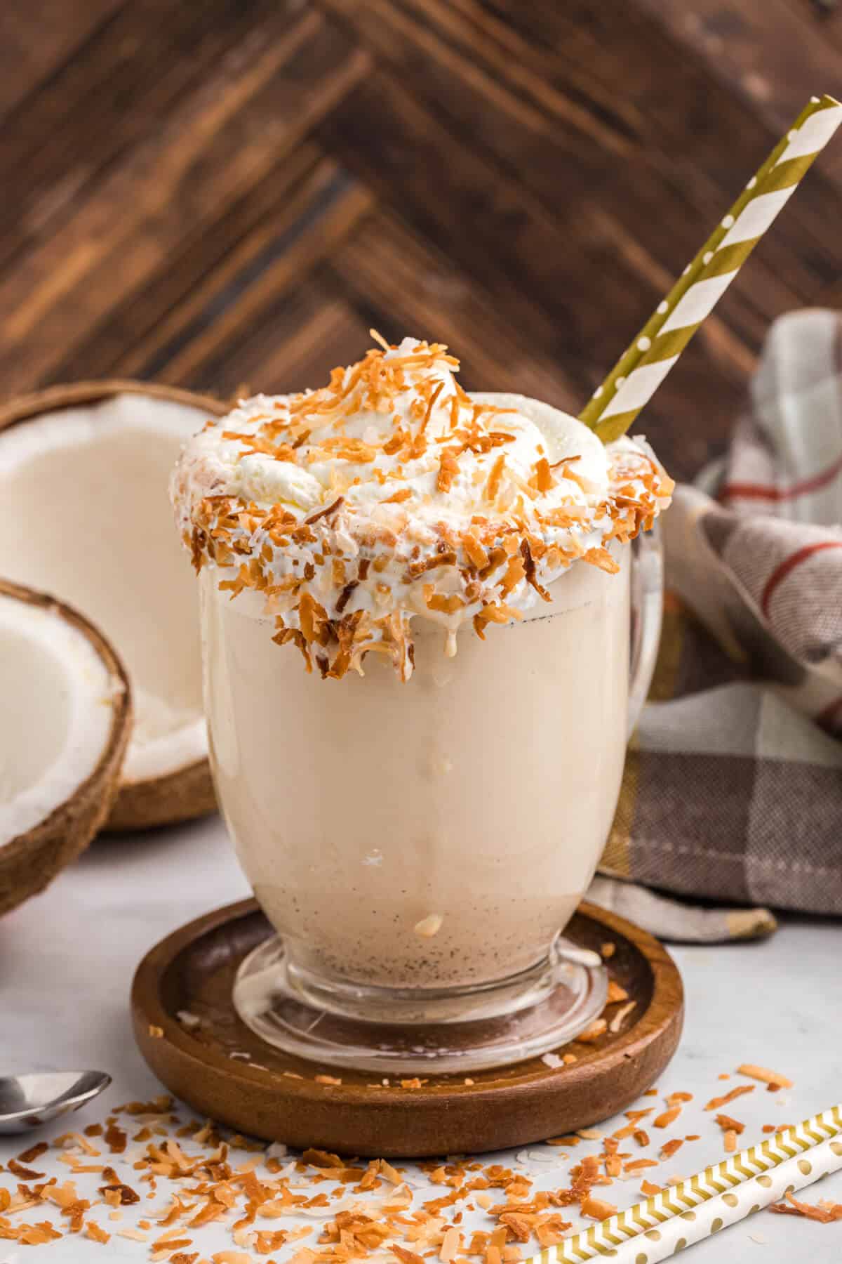 Coconut coffee milkshake on a wooden coaster.