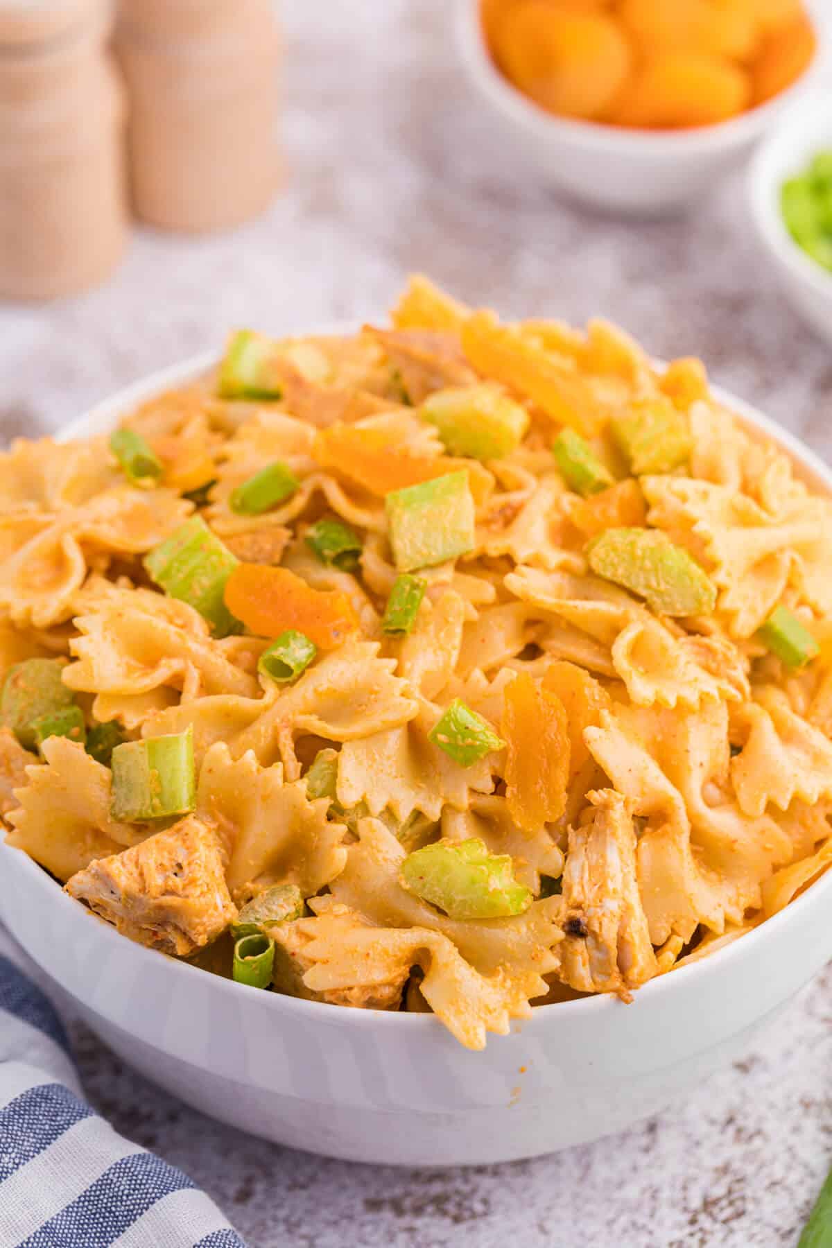 A bowl of creamy curried chicken pasta salad.