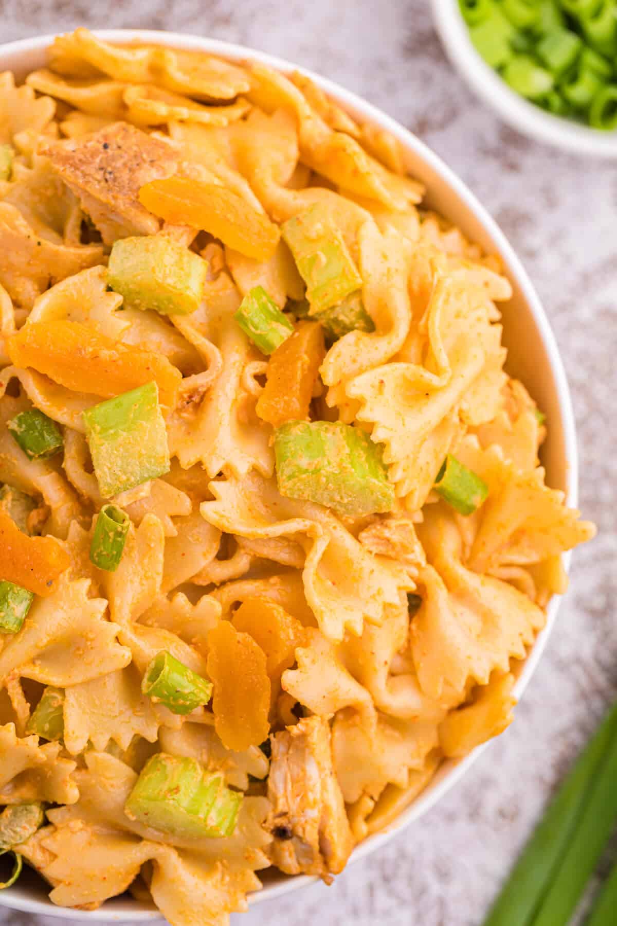 A bowl of creamy curried chicken pasta salad.