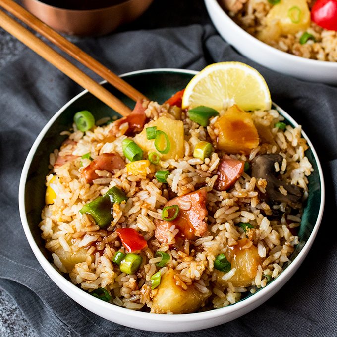 Hawaiian fried rice in a bowl with chopsticks.