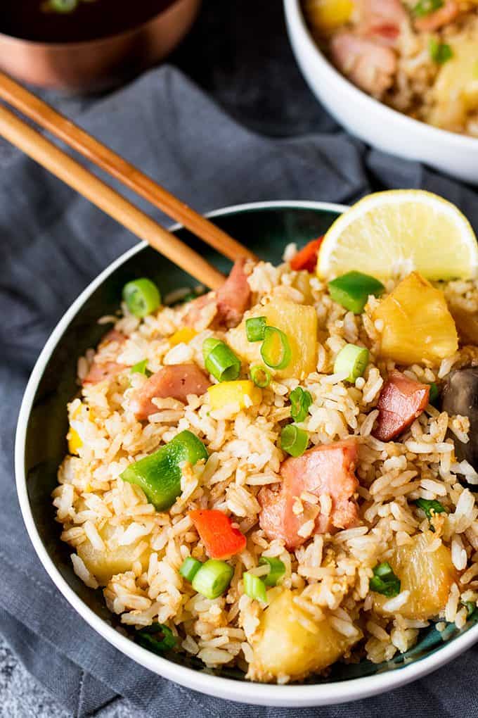 Hawaiian fried rice in a bowl with wooden chopsticks.