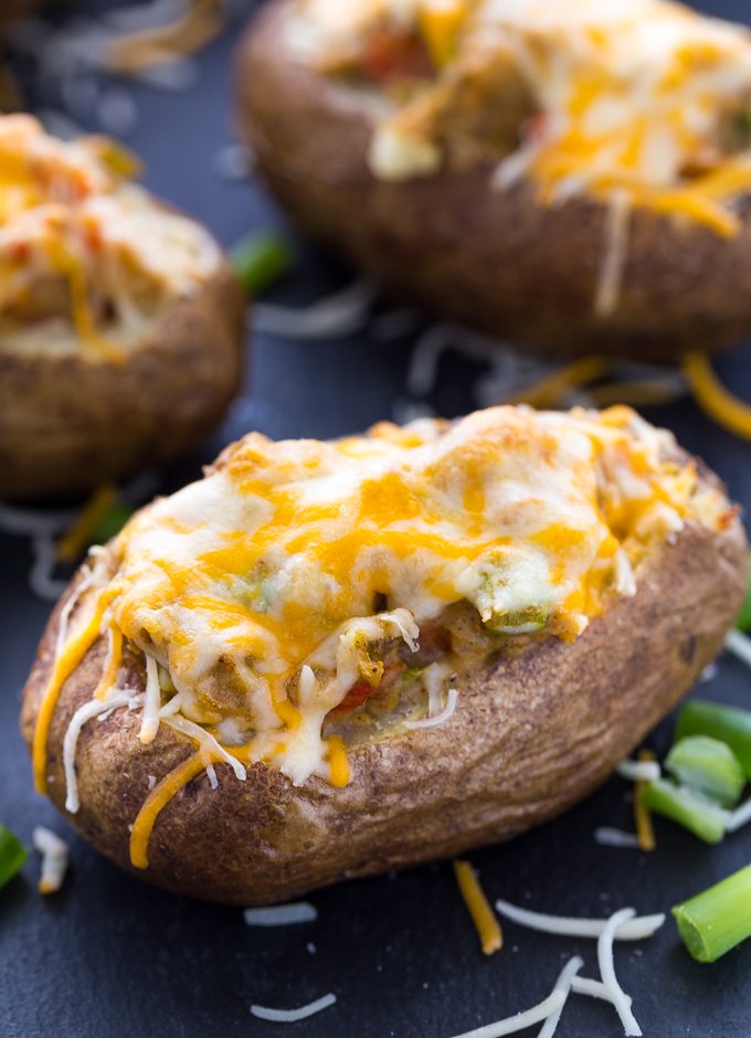 Twice Baked Pepper Stuffed Potatoes - The best twice baked potato recipe! Fill these fluffy potatoes with spicy peppers, cumin, chili powder, and sour cream.