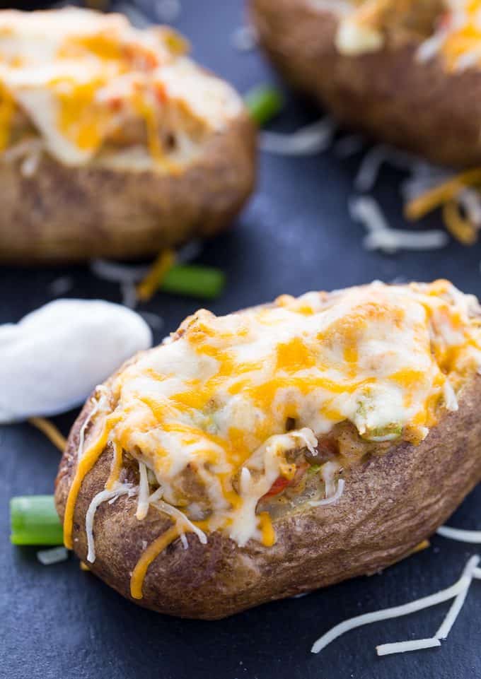 Twice Baked Pepper Stuffed Potatoes - The best twice baked potato recipe! Fill these fluffy potatoes with spicy peppers, cumin, chili powder, and sour cream.