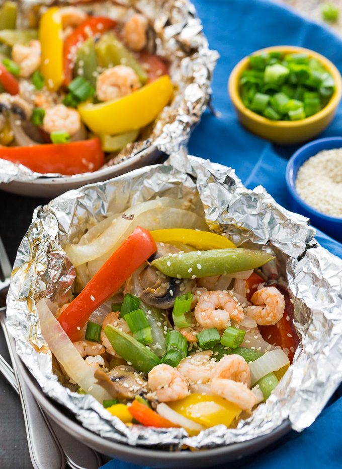 Grilled Sesame Shrimp & Veggies - This summer grilling recipe is a triple whammy - it's easy to prep, simple to cook and fast to clean up afterwards. Your family will love these individual foil packets filled with veggies, shrimp and a mouthwatering sesame sauce. 