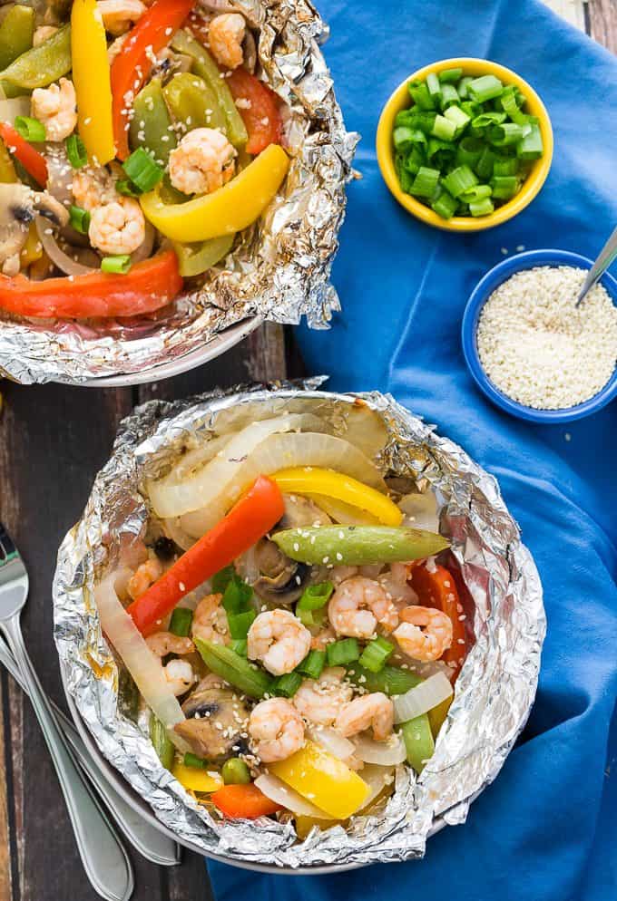 Grilled Sesame Shrimp & Veggies - This summer grilling recipe is a triple whammy - it's easy to prep, simple to cook and fast to clean up afterwards. Your family will love these individual foil packets filled with veggies, shrimp and a mouthwatering sesame sauce. 