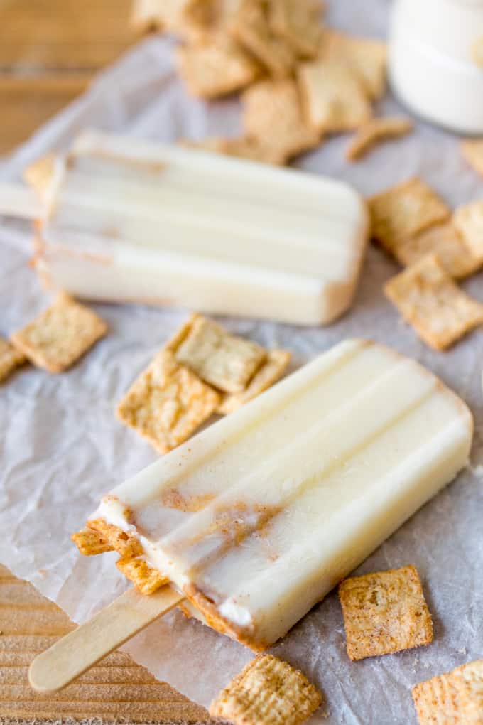 Cereal milk popsicles on a piece of parchment paper.