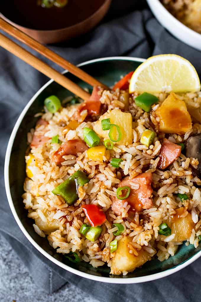 Hawaiian fried rice in a bowl with wooden chopsticks.
