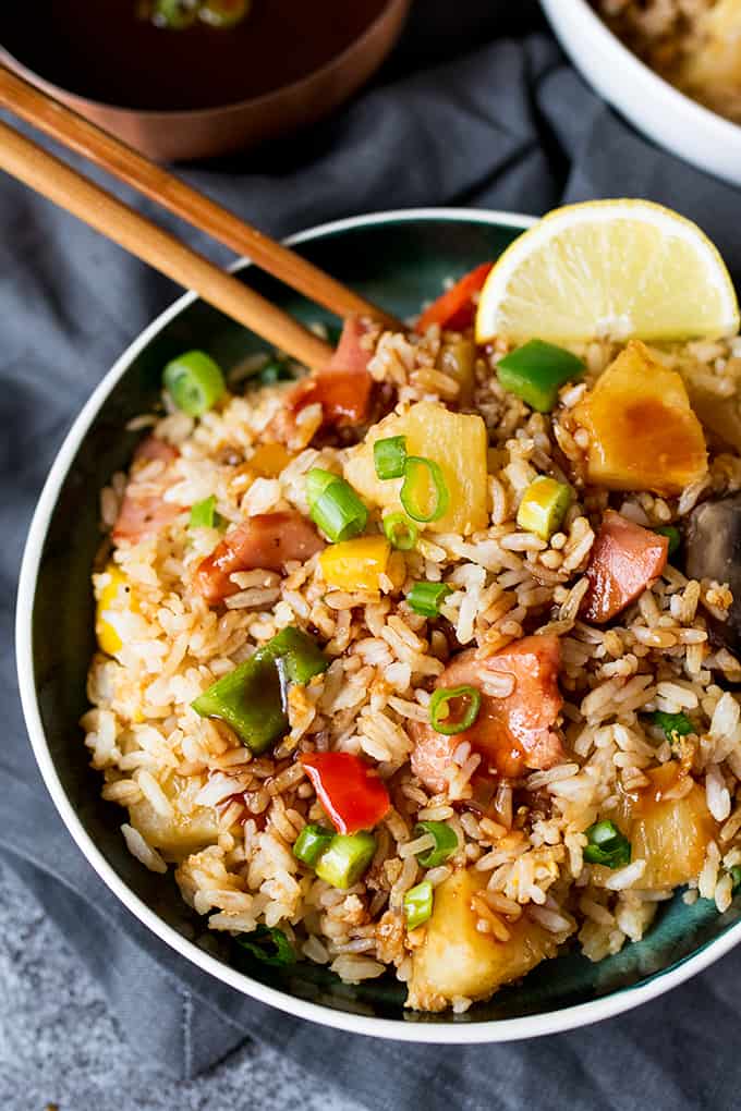 The rice in a bowl with wooden chopsticks.