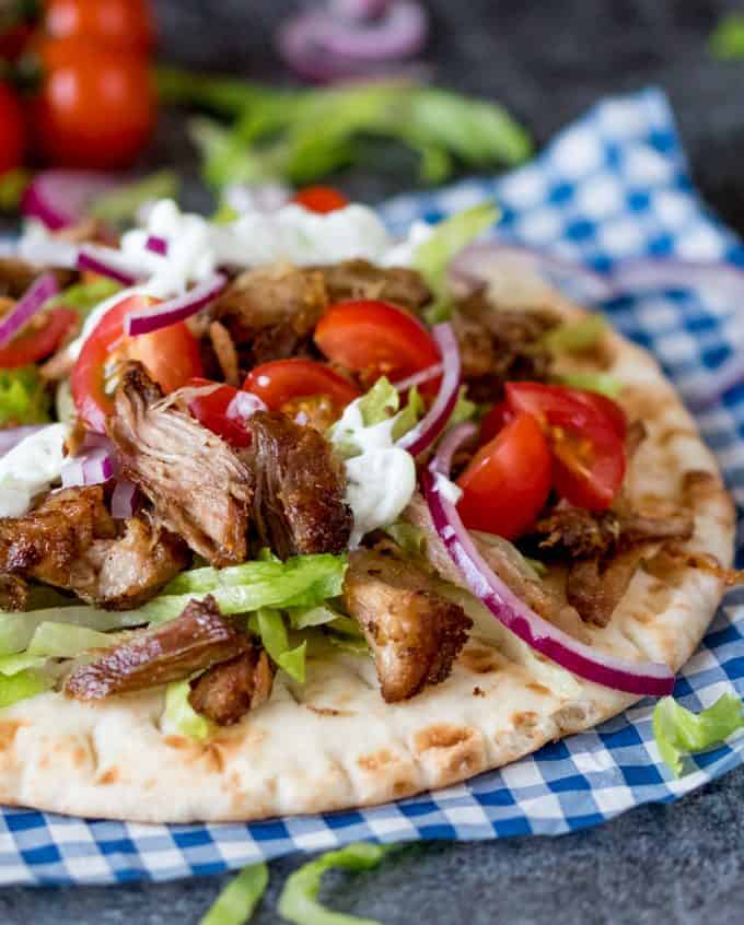 An open pork gyro on a napkin.