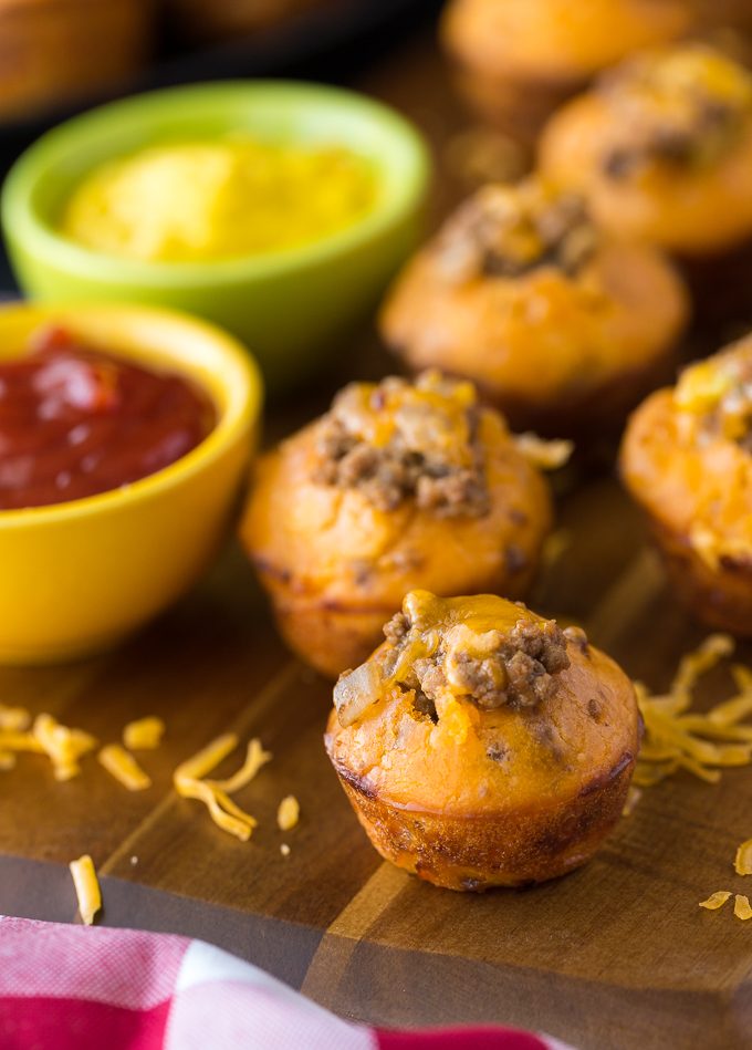 Cheeseburger Muffins - These tailgate treats are stuffed with your favorite burger toppings! Delicious dipped in ketchup and mustard.