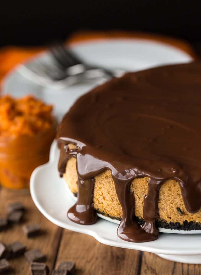 Chocolate Pumpkin Cheesecake - Prepared with a chocolate cookie crumb crust and a creamy, smooth pumpkin cheesecake filling. Topped off with a thick chocolate ganache, this is one scrumptious cheesecake. It tastes even better than it looks!