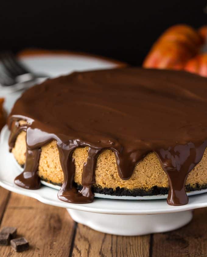 Chocolate Pumpkin Cheesecake - Prepared with a chocolate cookie crumb crust and a creamy, smooth pumpkin cheesecake filling. Topped off with a thick chocolate ganache, this is one scrumptious cheesecake. It tastes even better than it looks!