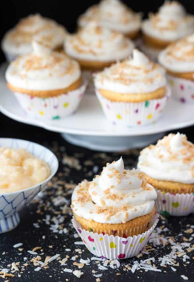 Coconut Cream Pie Cupcakes - Think Coconut Cream Pie but in a cupcake form. They have a pie crust, sweet coconut cupcake filled with a coconut cream pie pudding and topped with a beautiful coconut buttercream frosting.