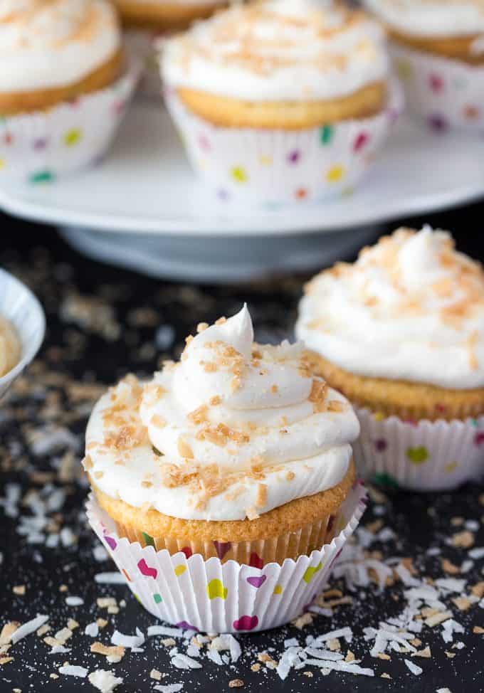 Coconut Cream Pie Cupcakes - Think Coconut Cream Pie but in a cupcake form. They have a pie crust, sweet coconut cupcake filled with a coconut cream pie pudding and topped with a beautiful coconut buttercream frosting.