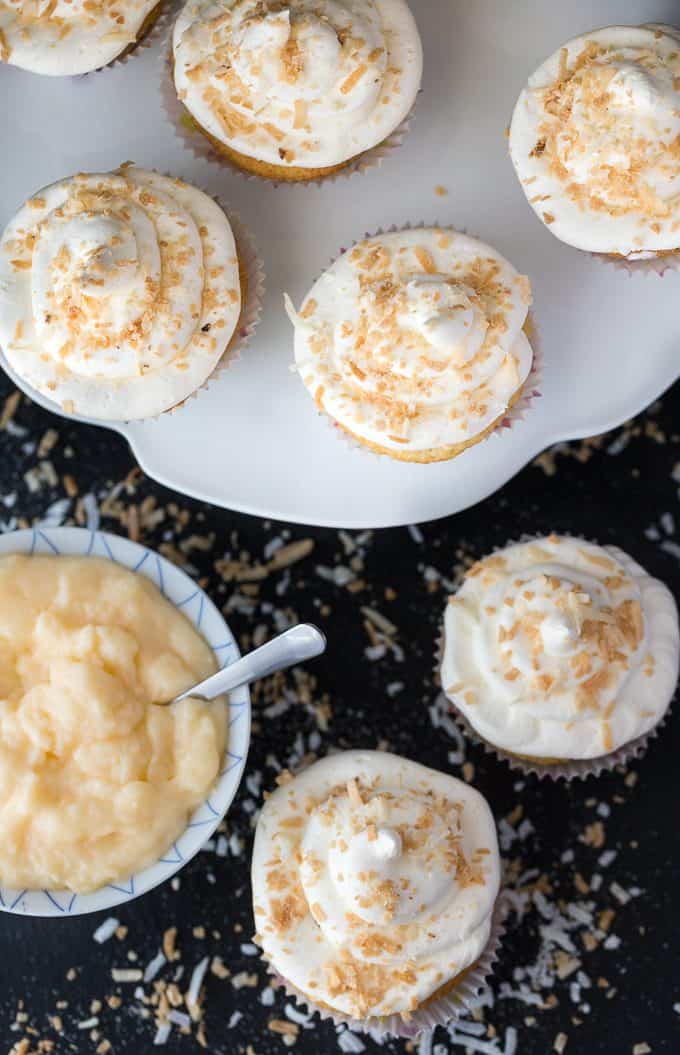 Coconut Cream Pie Cupcakes - Think Coconut Cream Pie but in a cupcake form. They have a pie crust, sweet coconut cupcake filled with a coconut cream pie pudding and topped with a beautiful coconut buttercream frosting.