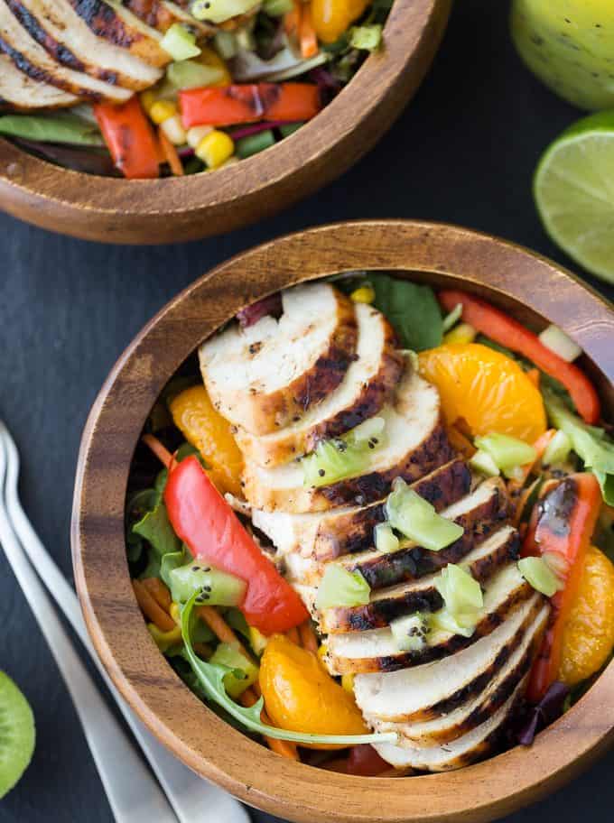 Sweet Heat Salad Recipe - Spicy and sweet meet for this dinner salad recipe! This Asian-inspired main dish is my take on the Swiss Chalet favorite with peppers, oranges, carrots, and a lime chili dressing.