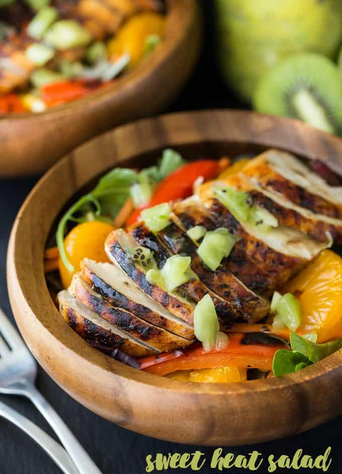 Sweet Heat Salad Recipe - Spicy and sweet meet for this dinner salad recipe! This Asian-inspired main dish is my take on the Swiss Chalet favorite with peppers, oranges, carrots, and a lime chili dressing.