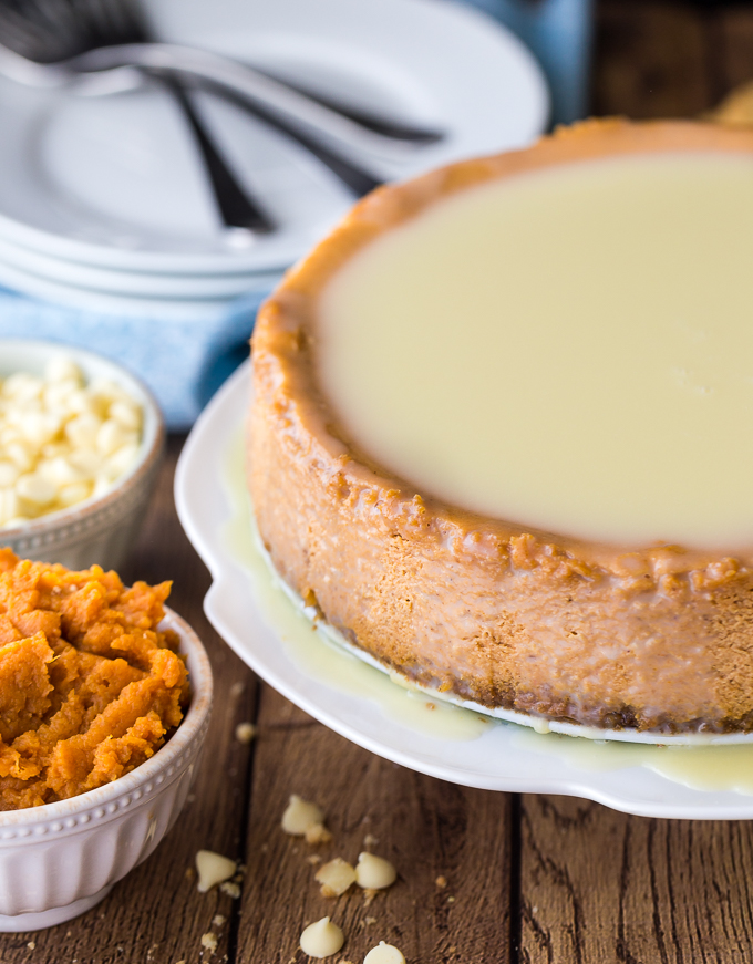 White Chocolate Pumpkin Cheesecake - The perfect fall dessert! Creamy and rich cheesecake with a pumpkin spice twist. The white chocolate glaze is the ultimate finish.