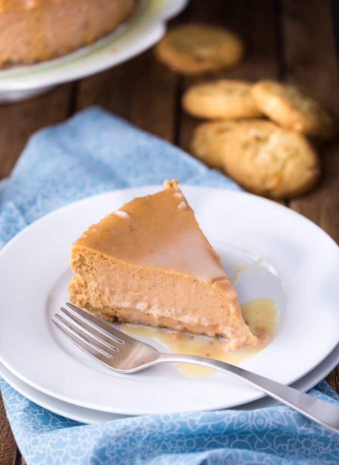 White Chocolate Pumpkin Cheesecake - The perfect fall dessert! Creamy and rich cheesecake with a pumpkin spice twist. The white chocolate glaze is the ultimate finish.