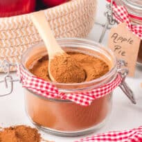 The spice in jar with a wooden spoon.