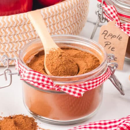 The spice in jar with a wooden spoon.