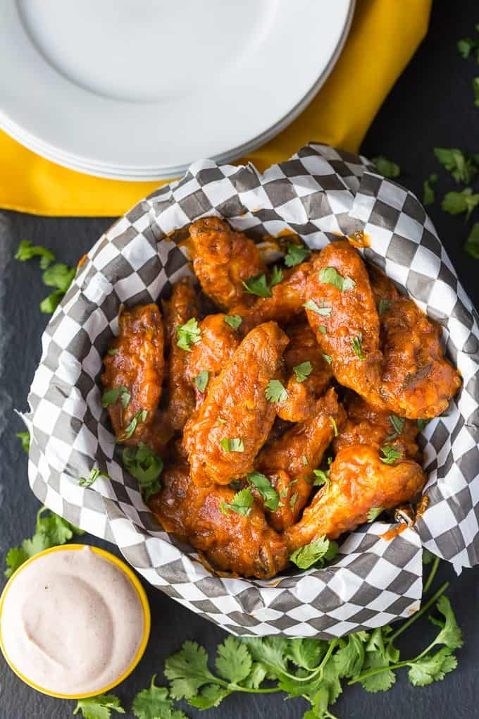 Spicy Butter Chicken Wings - Take your tailgate to India! These game day treats pack a little heat and a ton of flavor with a delicious dipping sauce.