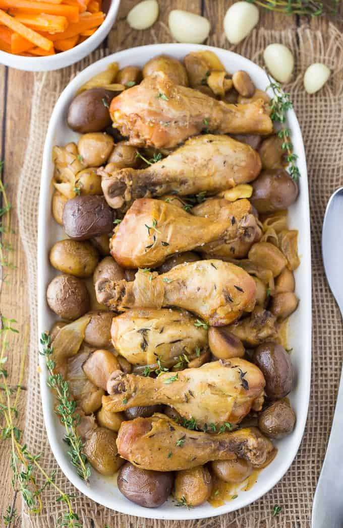 Slow Cooker 40 Clove Garlic Chicken - The most succulent chicken recipe ever! Bust out the garlic for this amazing Crockpot chicken and potatoes that are bursting with flavor.