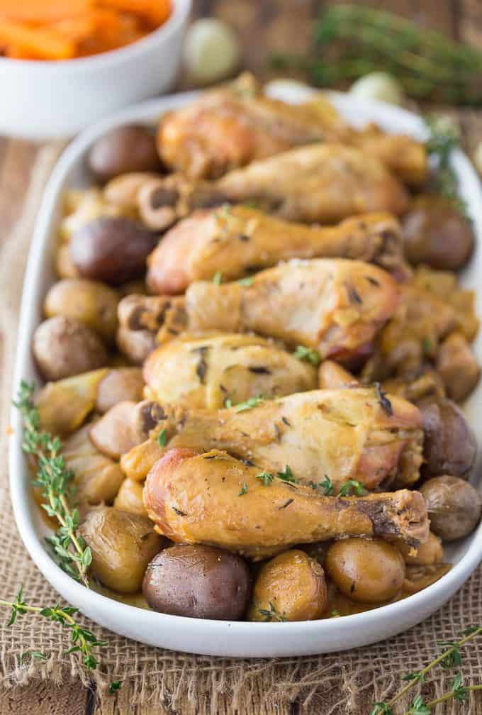 Slow Cooker 40 Clove Garlic Chicken - The most succulent chicken recipe ever! Bust out the garlic for this amazing Crockpot chicken and potatoes that are bursting with flavor.