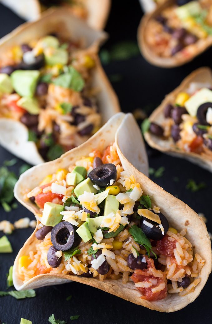 Black Bean & Rice Open-Faced Tacos - The easiest vegetarian taco recipe! These tortilla bowls are stuffed with Mexican rice and can be topped with all your favorites.