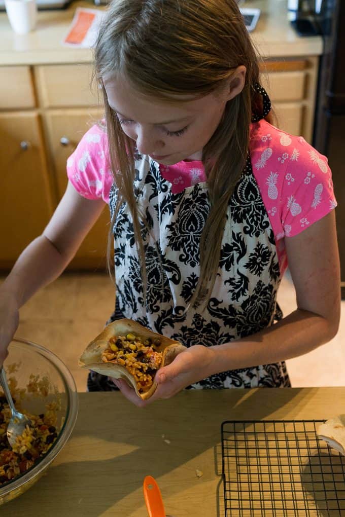 Black Bean & Rice Open-Faced Tacos - Kids love to help make this recipe of yummy tortilla bowls filled with flavourful Mexican rice.