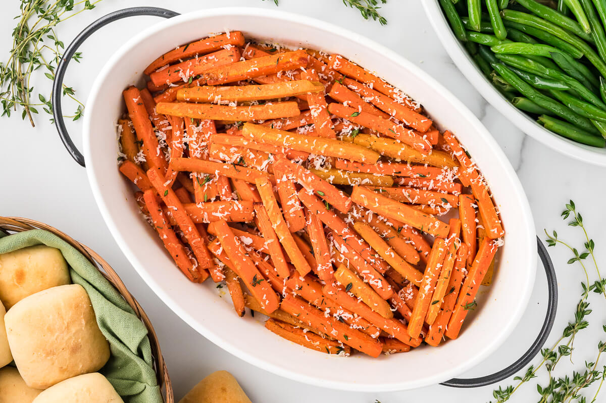 Parmesan roasted carrots in a white casserole dish.