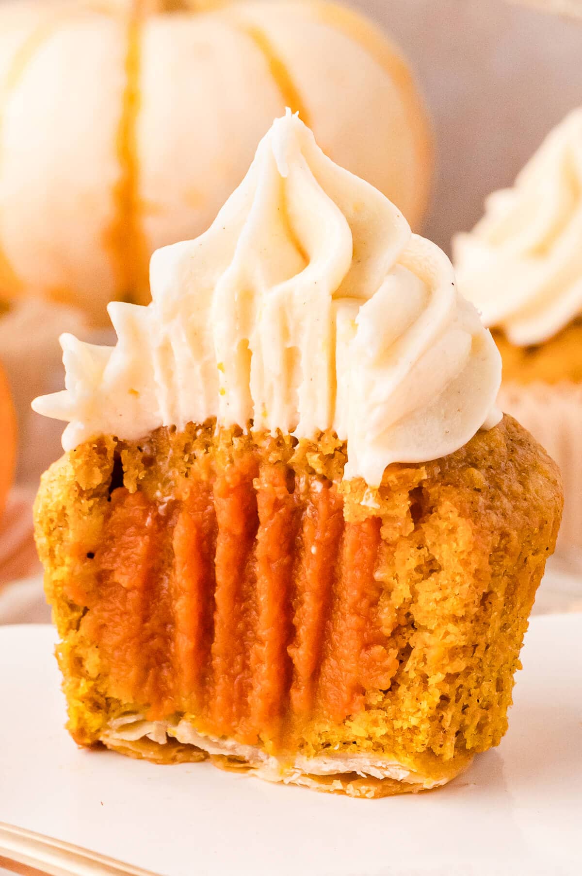 A cupcake sliced in half on a plate.