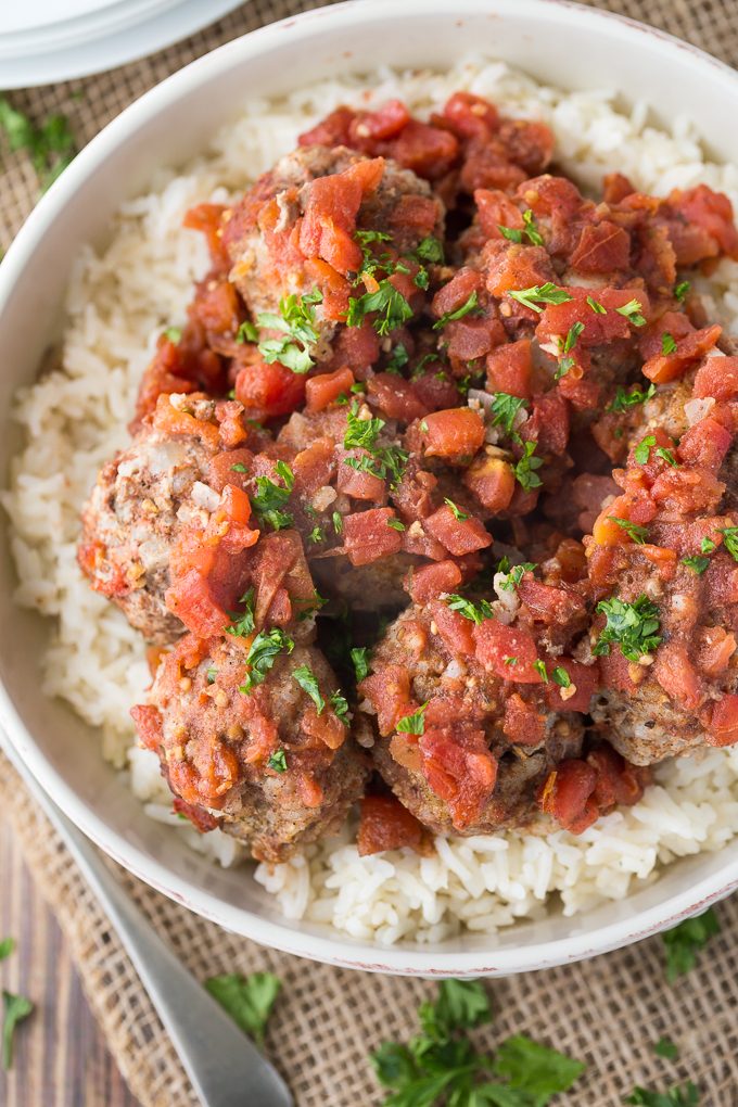 Meatballs & Rice - These simple beef meatballs are served with a spiced tomato sauce over a bed of rice. There's rice in the meatballs too for the fluffiest texture!