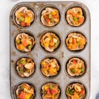 Chicken Fajita Wonton Cups - A little East, a little West. These appetizer cups are perfect for entertaining with a festive Mexican filling in a crunchy wonton.