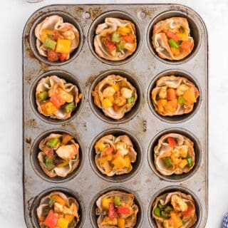 Chicken Fajita Wonton Cups - A little East, a little West. These appetizer cups are perfect for entertaining with a festive Mexican filling in a crunchy wonton.