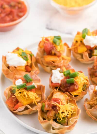Chicken Fajita Wonton Cups - A little East, a little West. These appetizer cups are perfect for entertaining with a festive Mexican filling in a crunchy wonton.