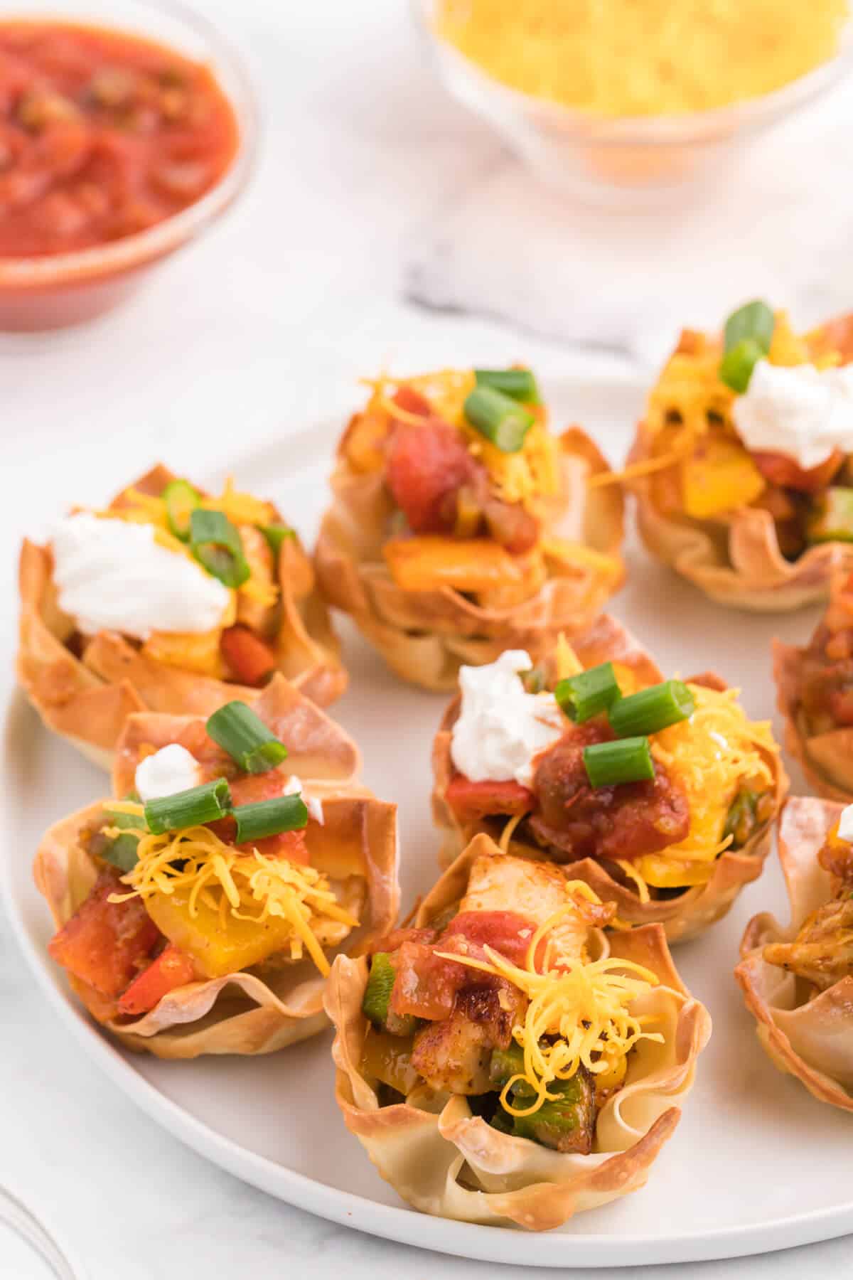 Chicken Fajita Wonton Cups - A little East, a little West. These appetizer cups are perfect for entertaining with a festive Mexican filling in a crunchy wonton.