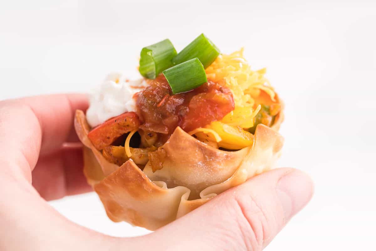 Chicken Fajita Wonton Cups - A little East, a little West. These appetizer cups are perfect for entertaining with a festive Mexican filling in a crunchy wonton.