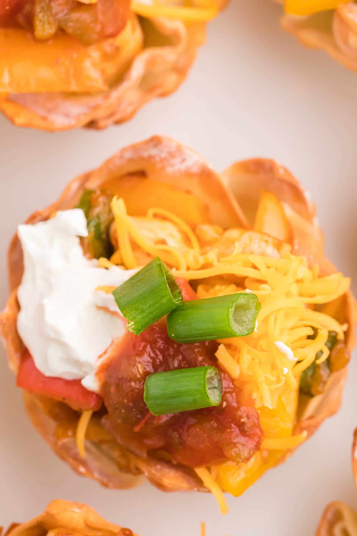 Chicken Fajita Wonton Cups - A little East, a little West. These appetizer cups are perfect for entertaining with a festive Mexican filling in a crunchy wonton.