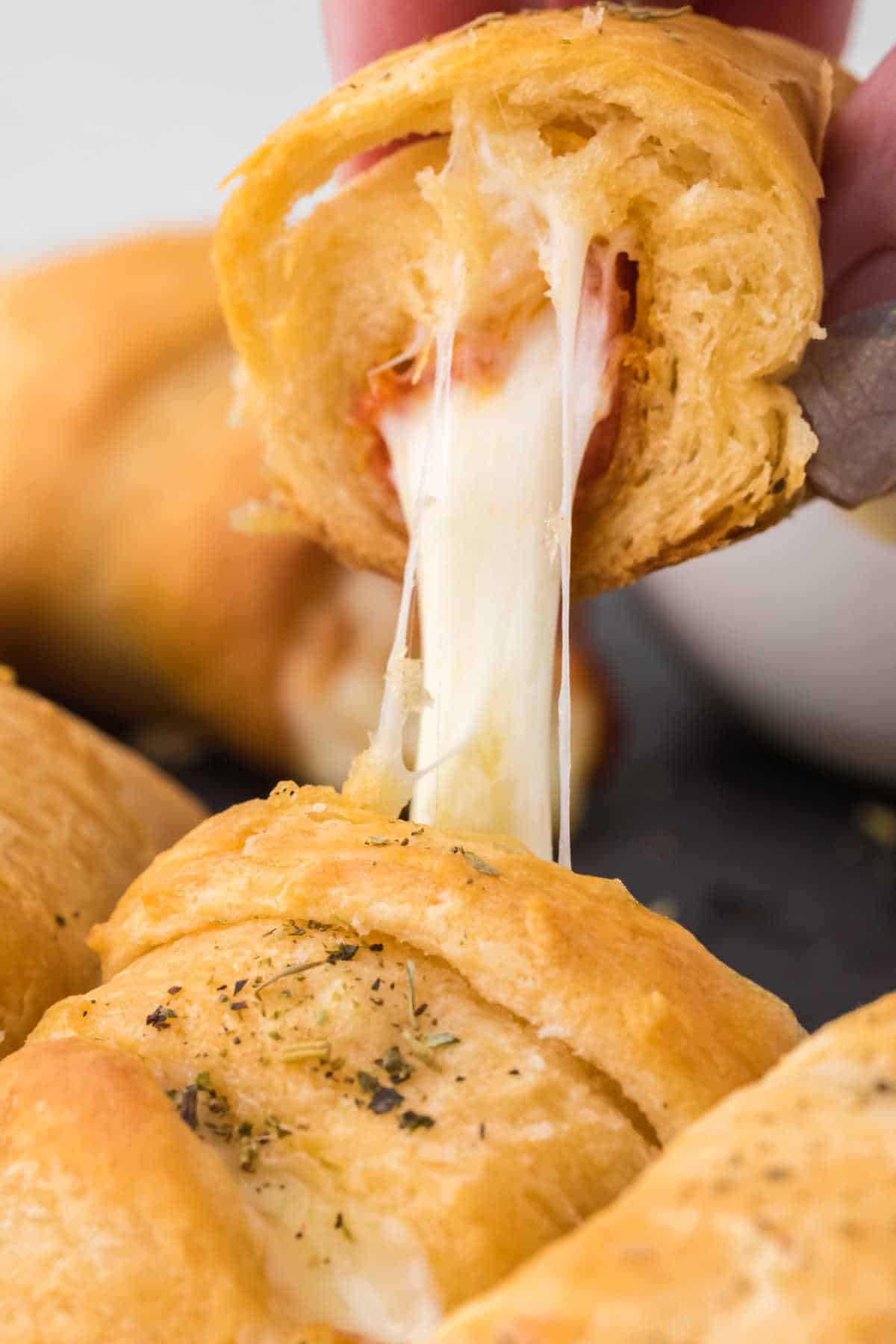 Pizza roll cut in half with cheese coming out.