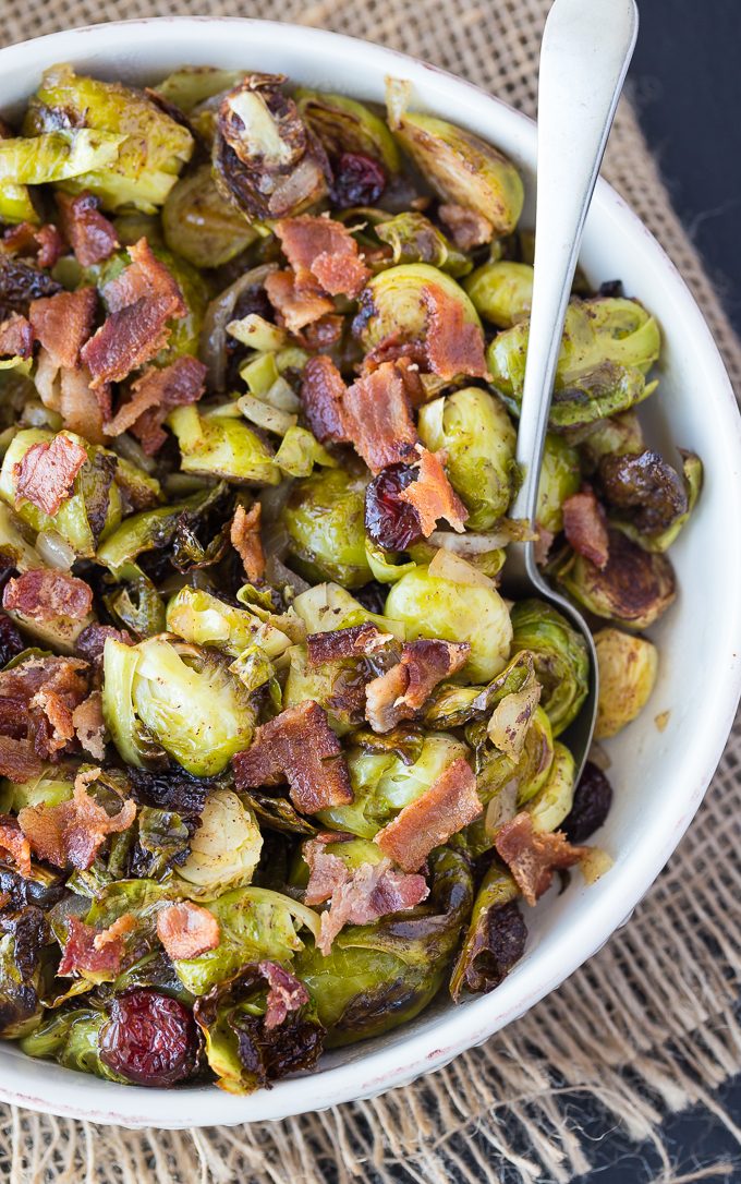 Roasted Brussel Sprouts with Cranberries & Bacon - Brussel Sprouts are roasted to perfection and topped with a sweet/savoury cranberry onion glaze. This recipe makes a wonderful addition to your holiday dinner table!