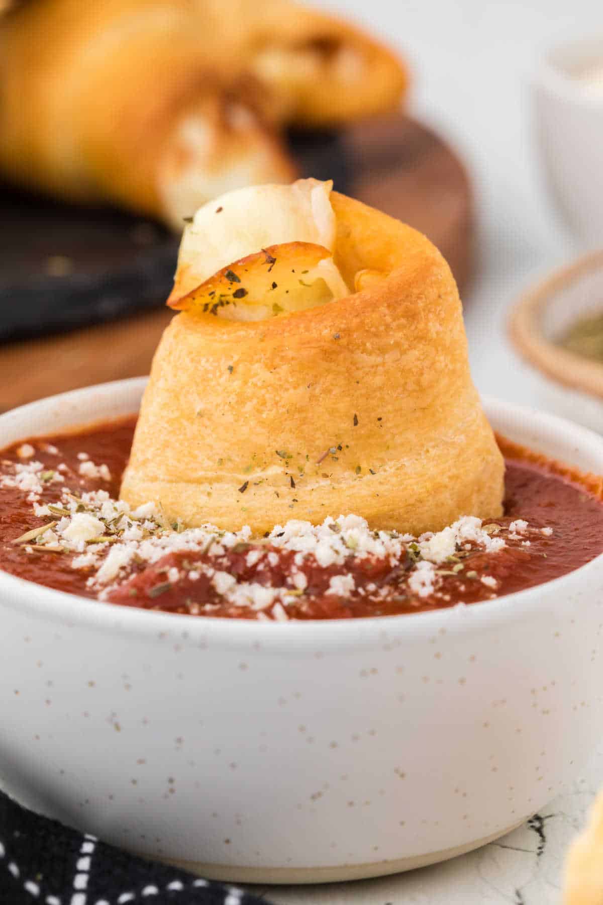 A pizza roll dunked in pizza sauce.