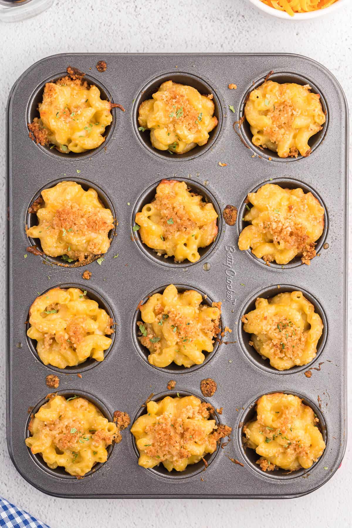 Mac and Cheese Cups - Comfort food in a cup! The perfect cozy, cheesy side dish, but handheld for appetizers and tailgating.