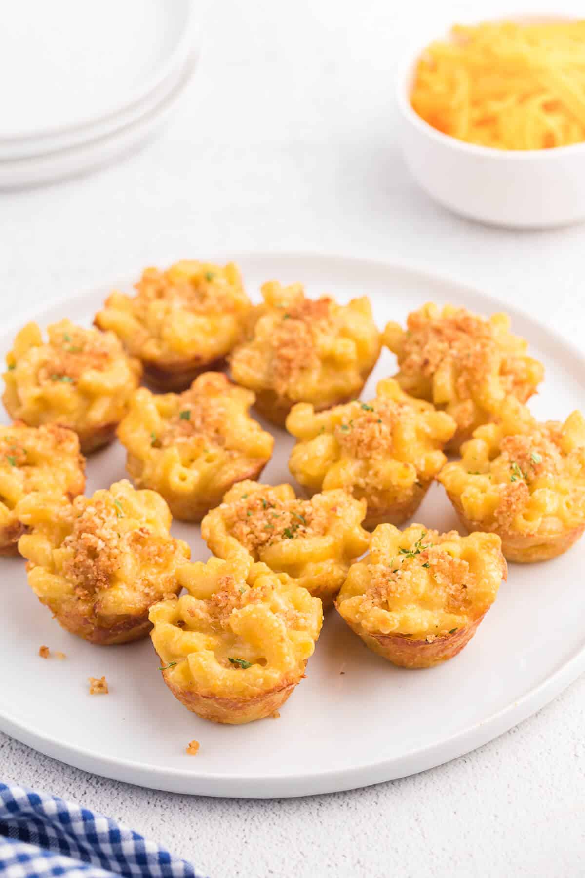 Photo of mac and cheese cups on a white plate.