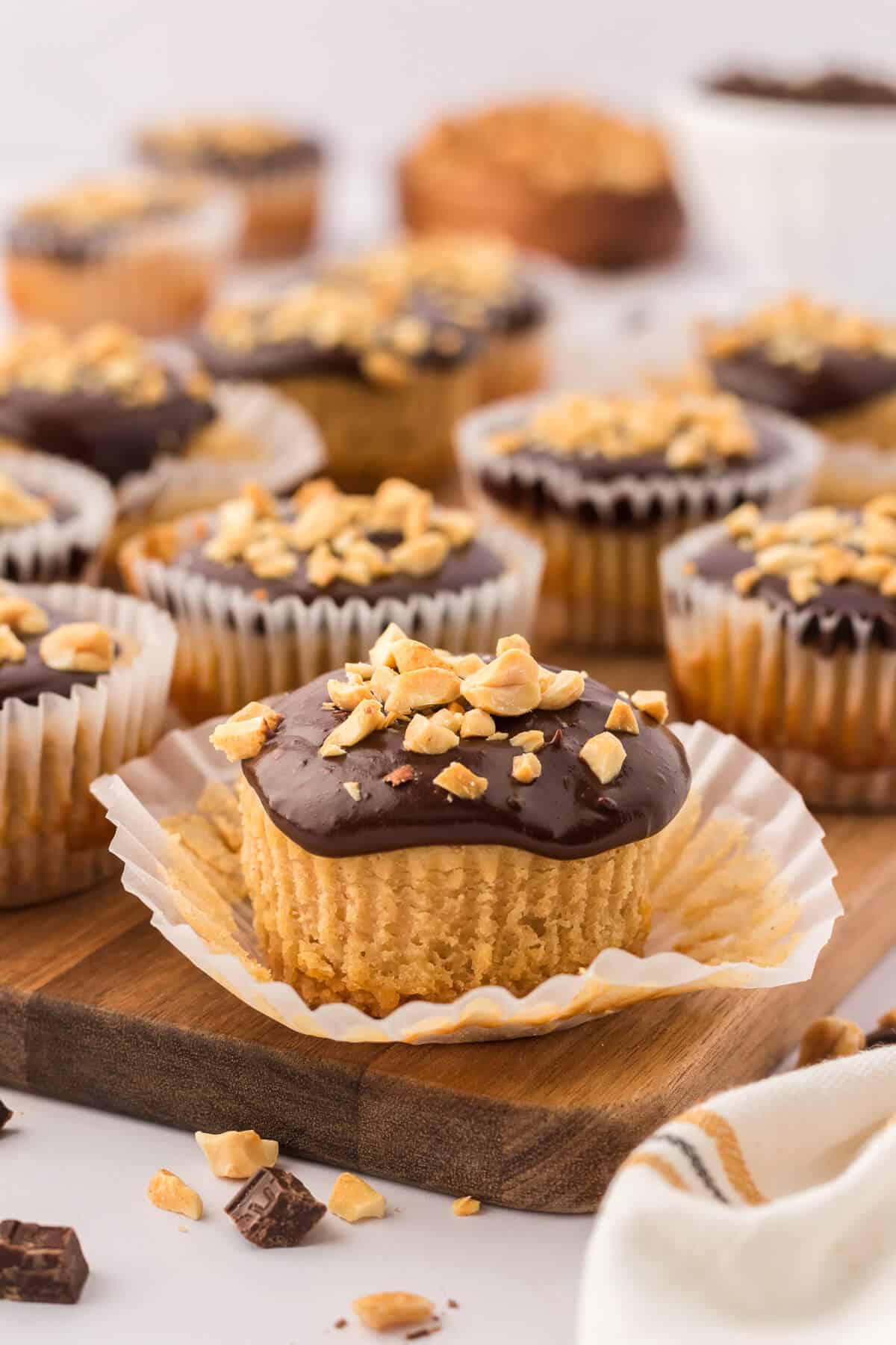 A mini peanut butter cheesecake with the liner half removed.