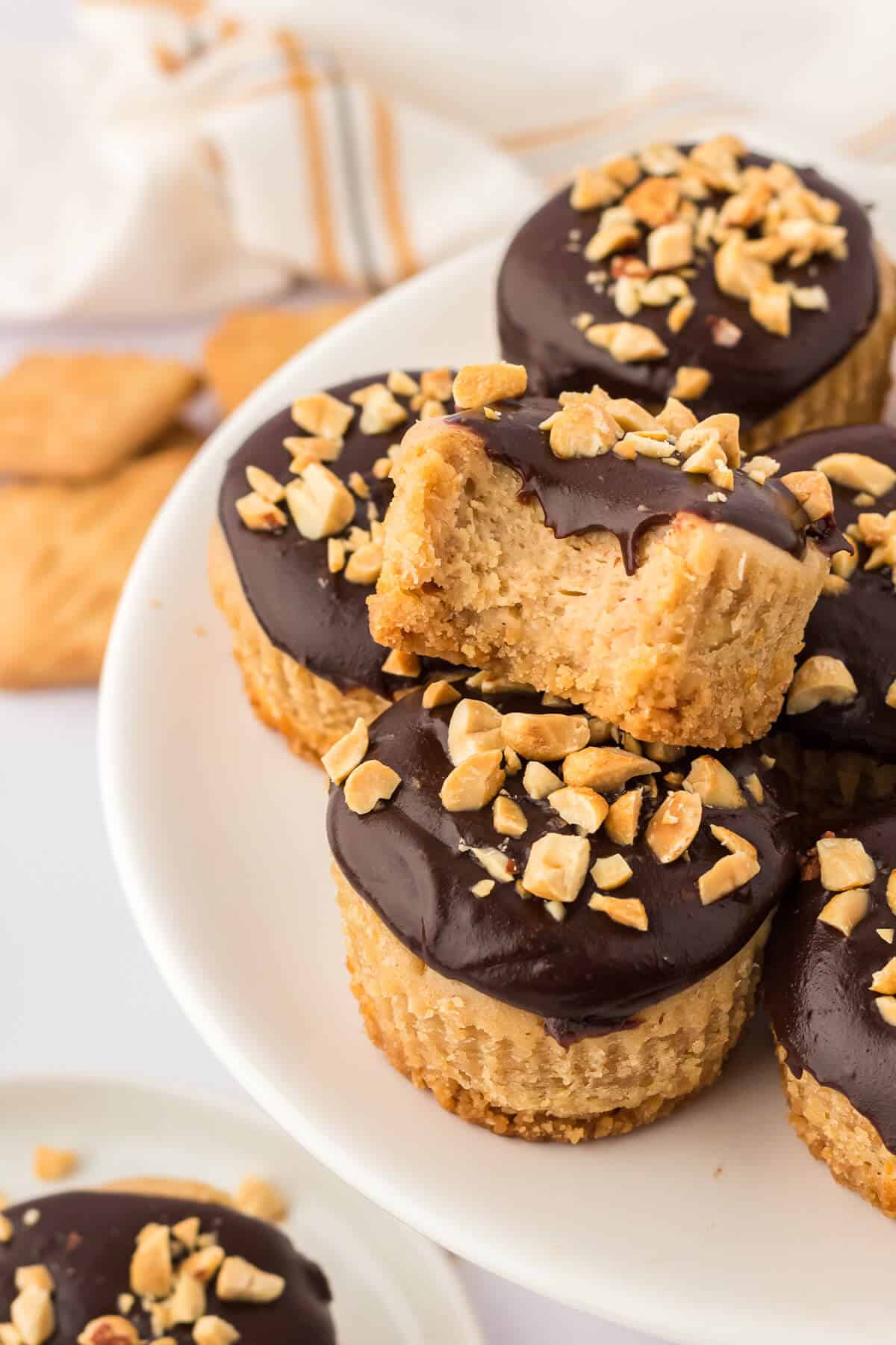 A pile of mini peanut butter cheesecakes on a plate.