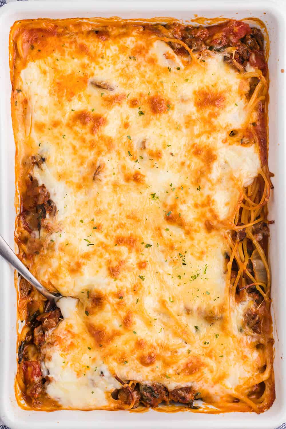 overhead shot of spaghetti bake in a white casserole dish