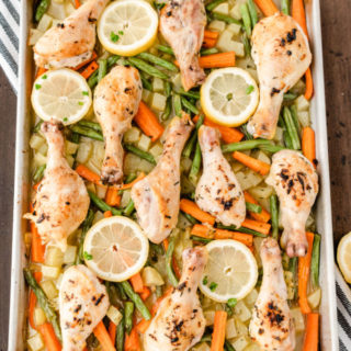 One-Pan Lemon Thyme Chicken - Tender, flavourful chicken drumsticks covered in a lemon/herb butter spread are roasted to perfection along with carrots, potatoes and green beans on one pan! You'll love how easy it is to make and clean.