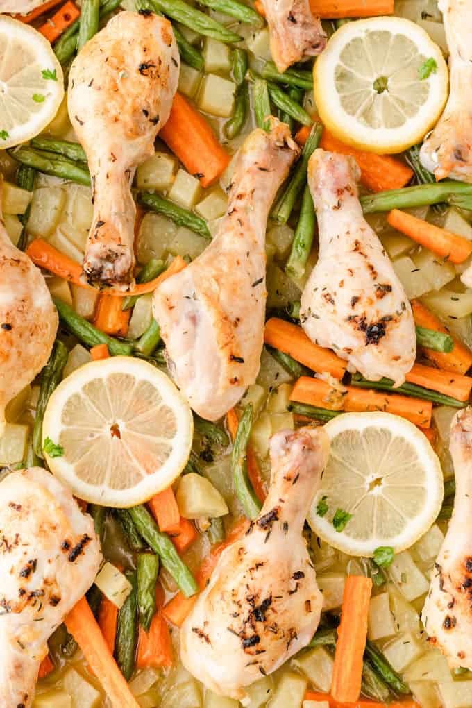 One-Pan Lemon Thyme Chicken - Tender, flavourful chicken drumsticks covered in a lemon/herb butter spread are roasted to perfection along with carrots, potatoes and green beans on one pan! You'll love how easy it is to make and clean.