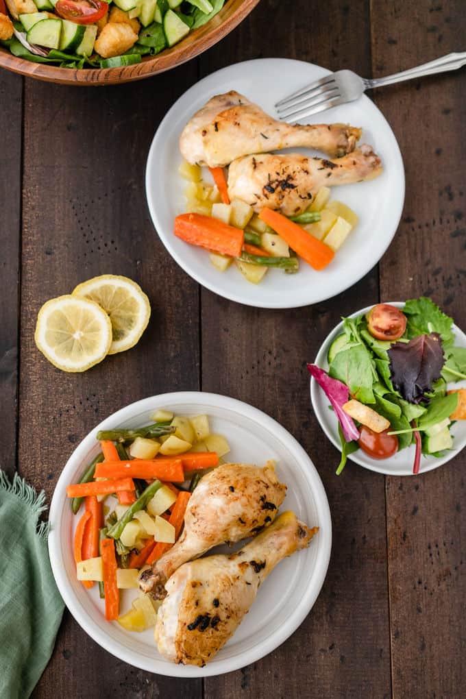 One-Pan Lemon Thyme Chicken - Tender, flavourful chicken drumsticks covered in a lemon/herb butter spread are roasted to perfection along with carrots, potatoes and green beans on one pan! You'll love how easy it is to make and clean.